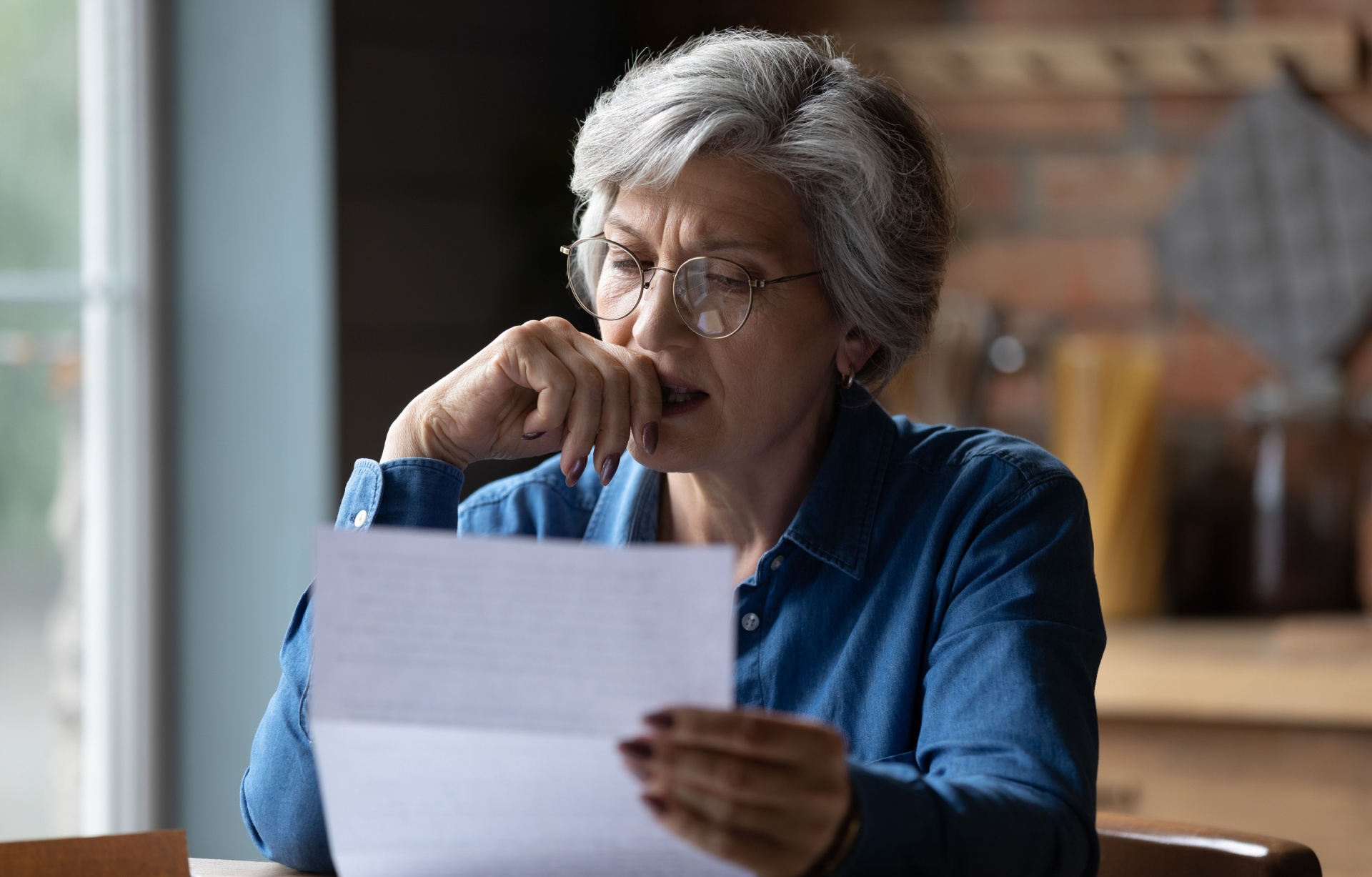 A woman reading a letter.