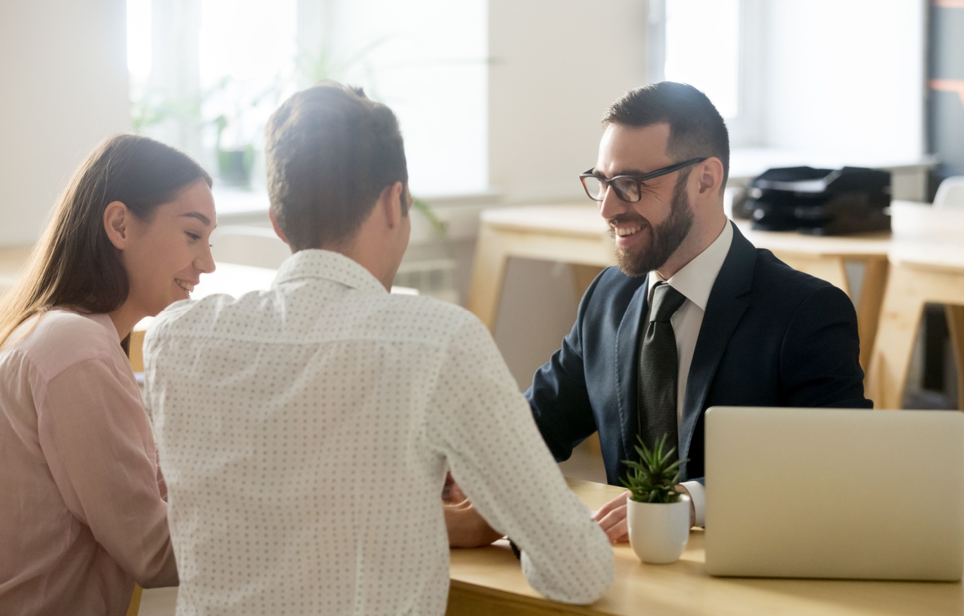 A young couple meeting with a financial planner.