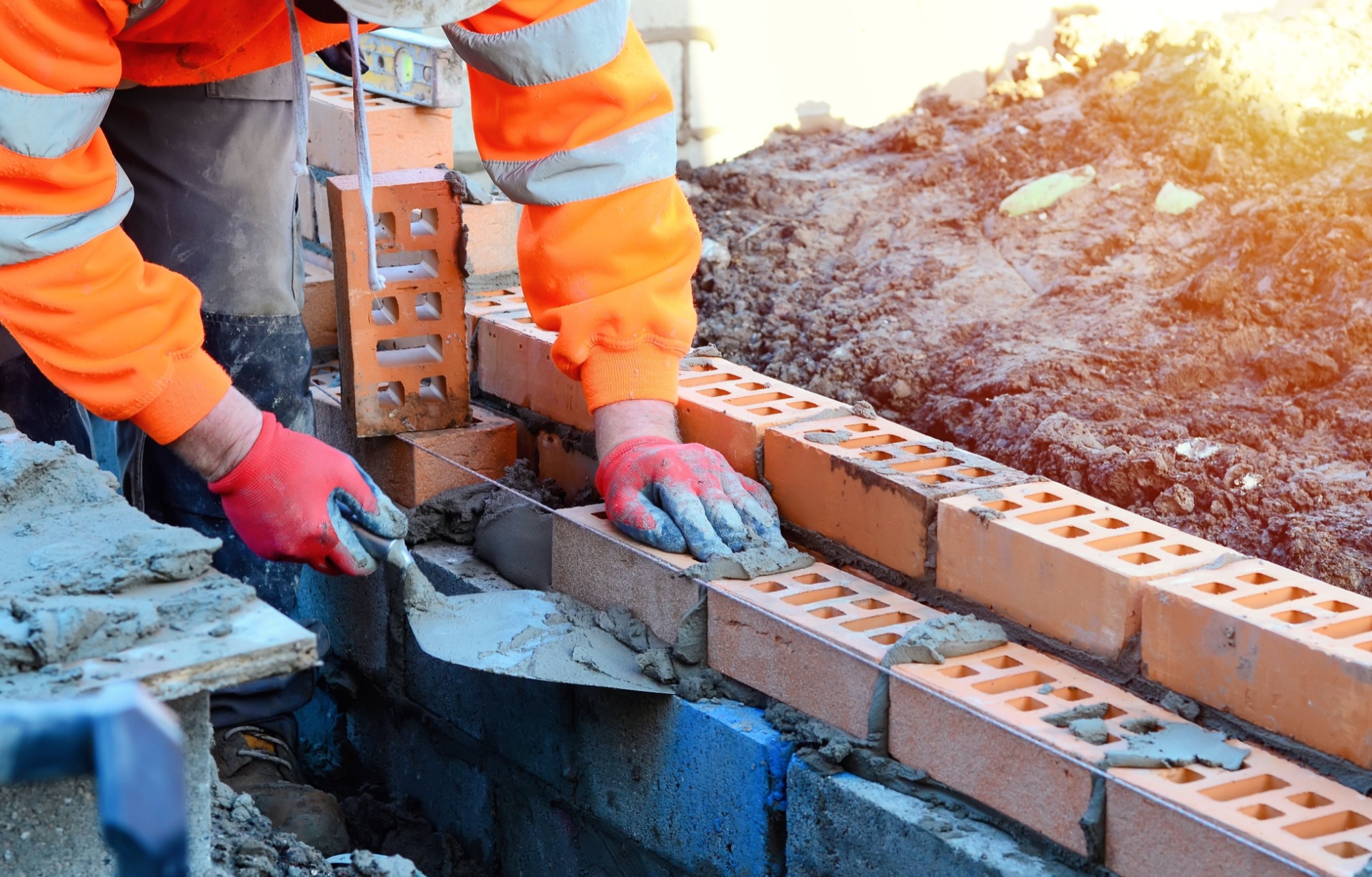 A bricklayer working on a construction site.
