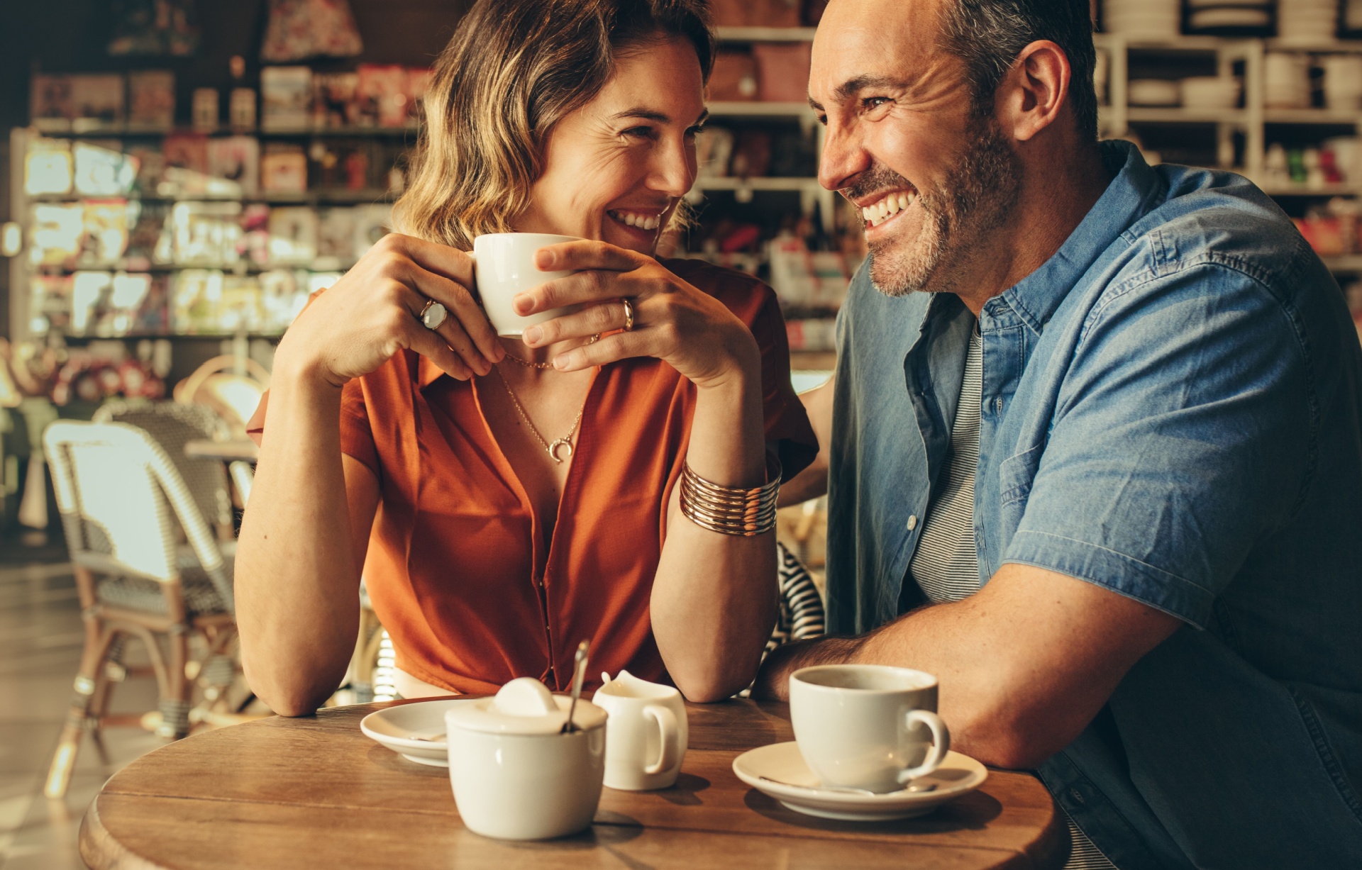 A couple laughing in a café.