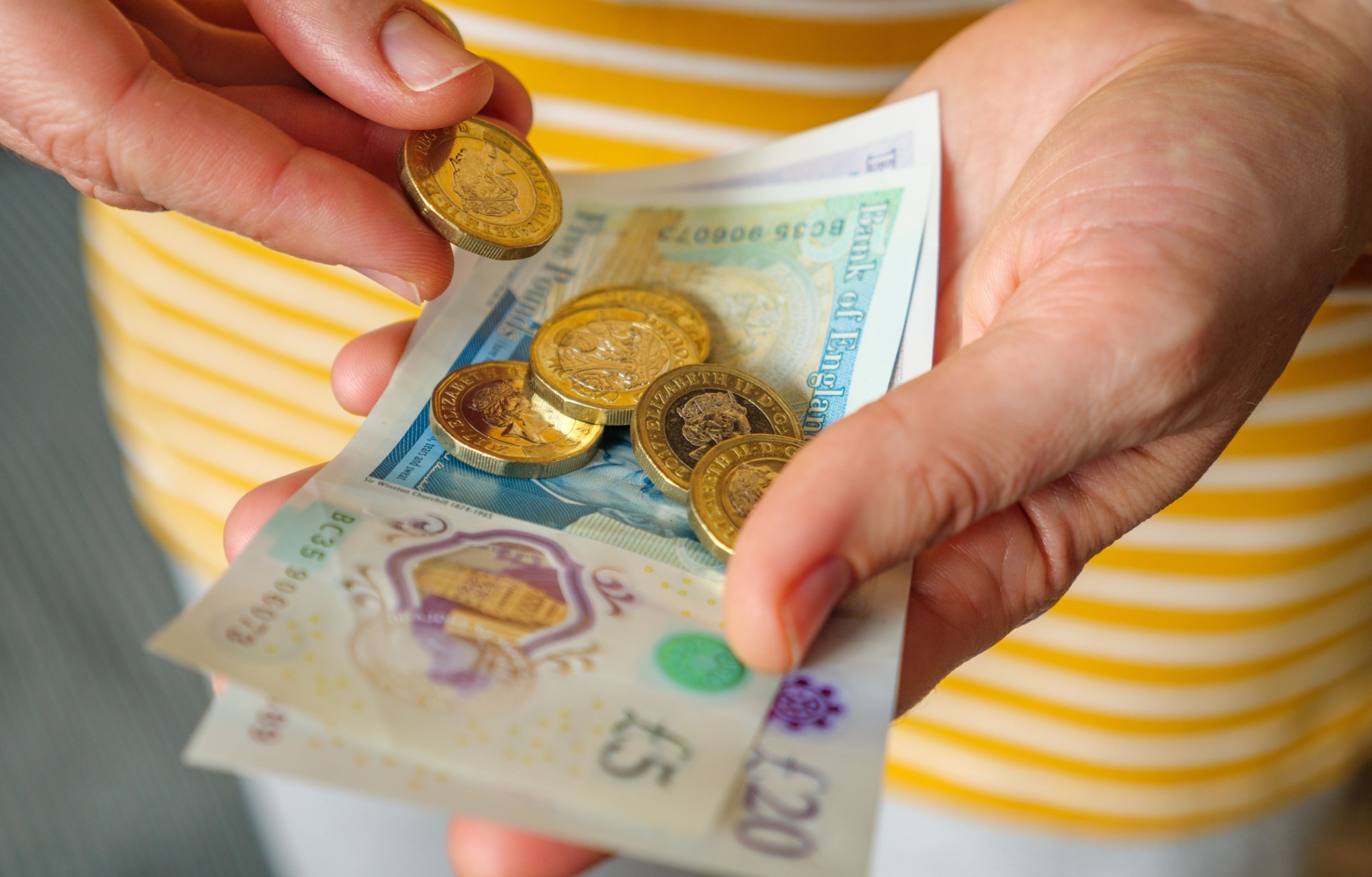 A woman holding cash in her hands.