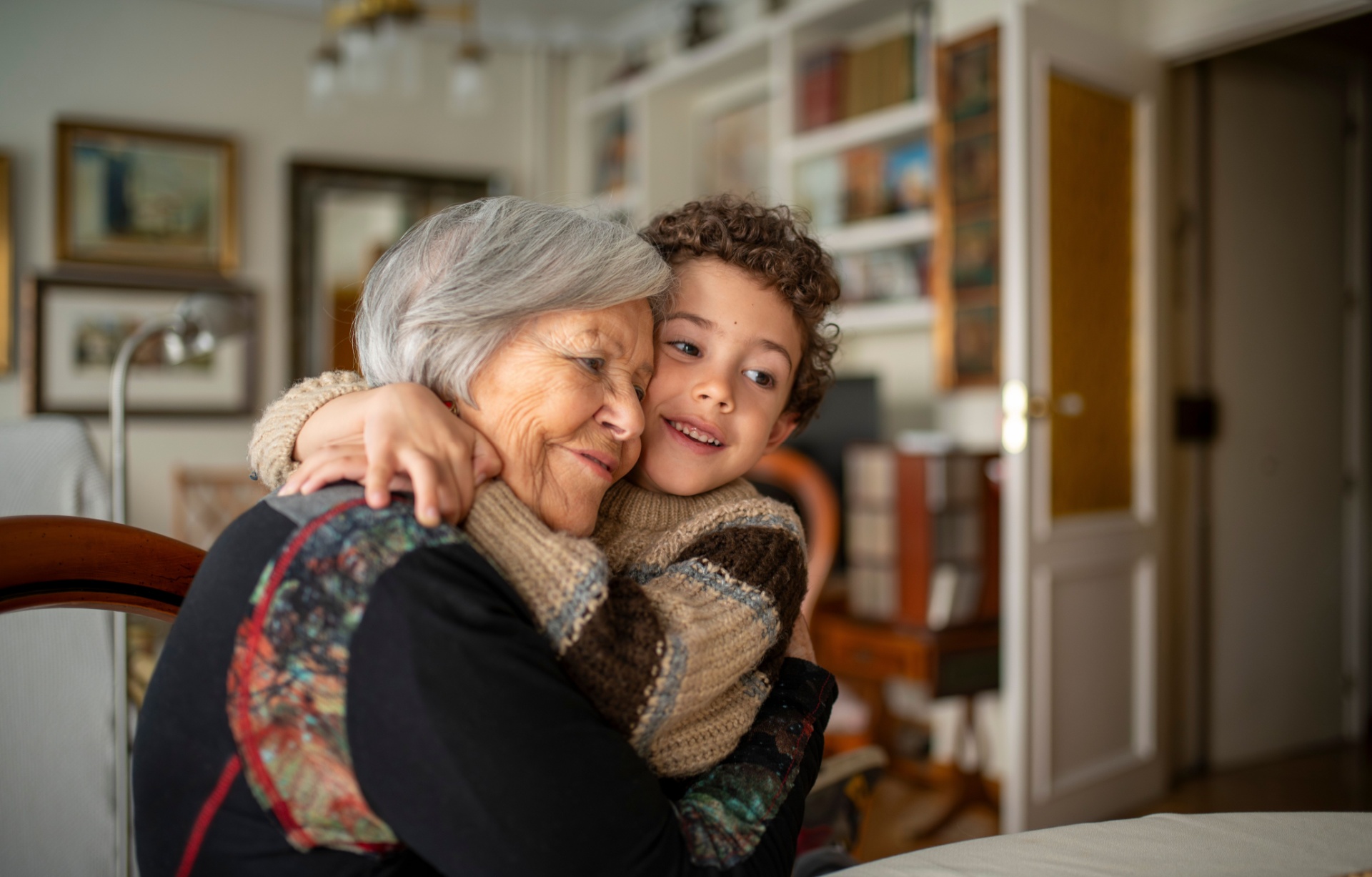 A woman hugging her grandchild.