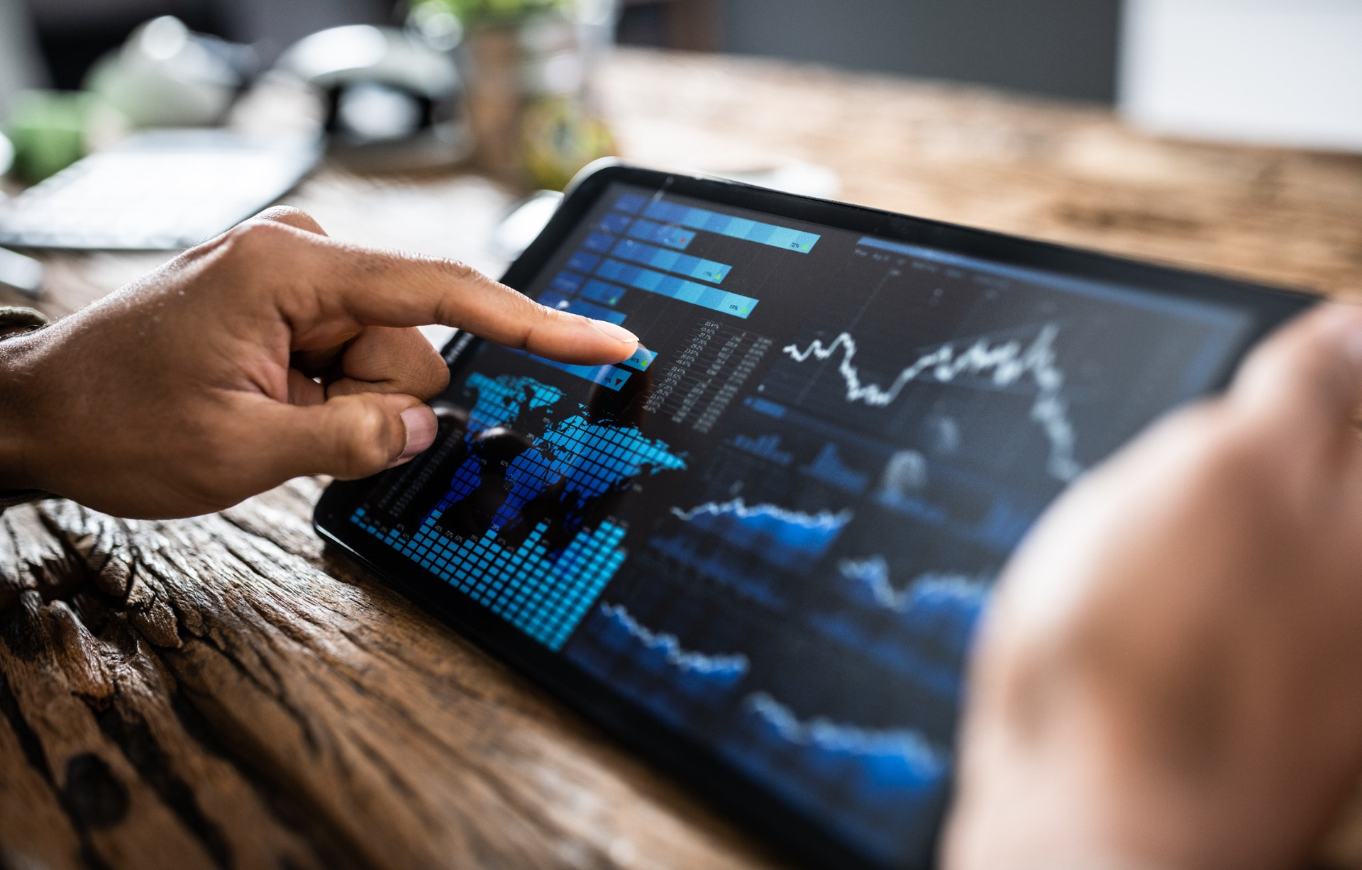 A person reviewing investment performance on a tablet.